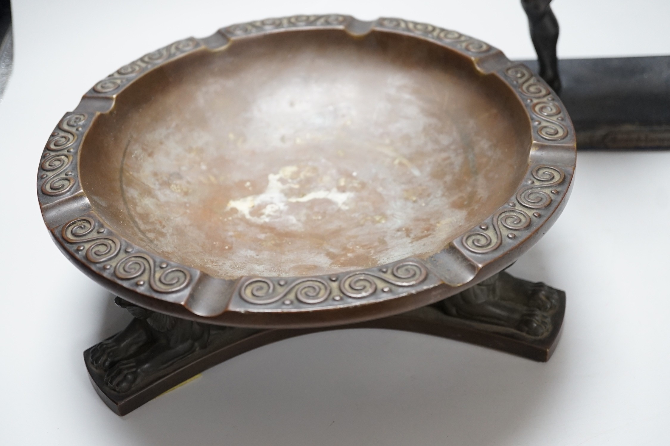 A large bronze dish, on triform lion base, and a bronze-finished warrior, dish 28cms diameter